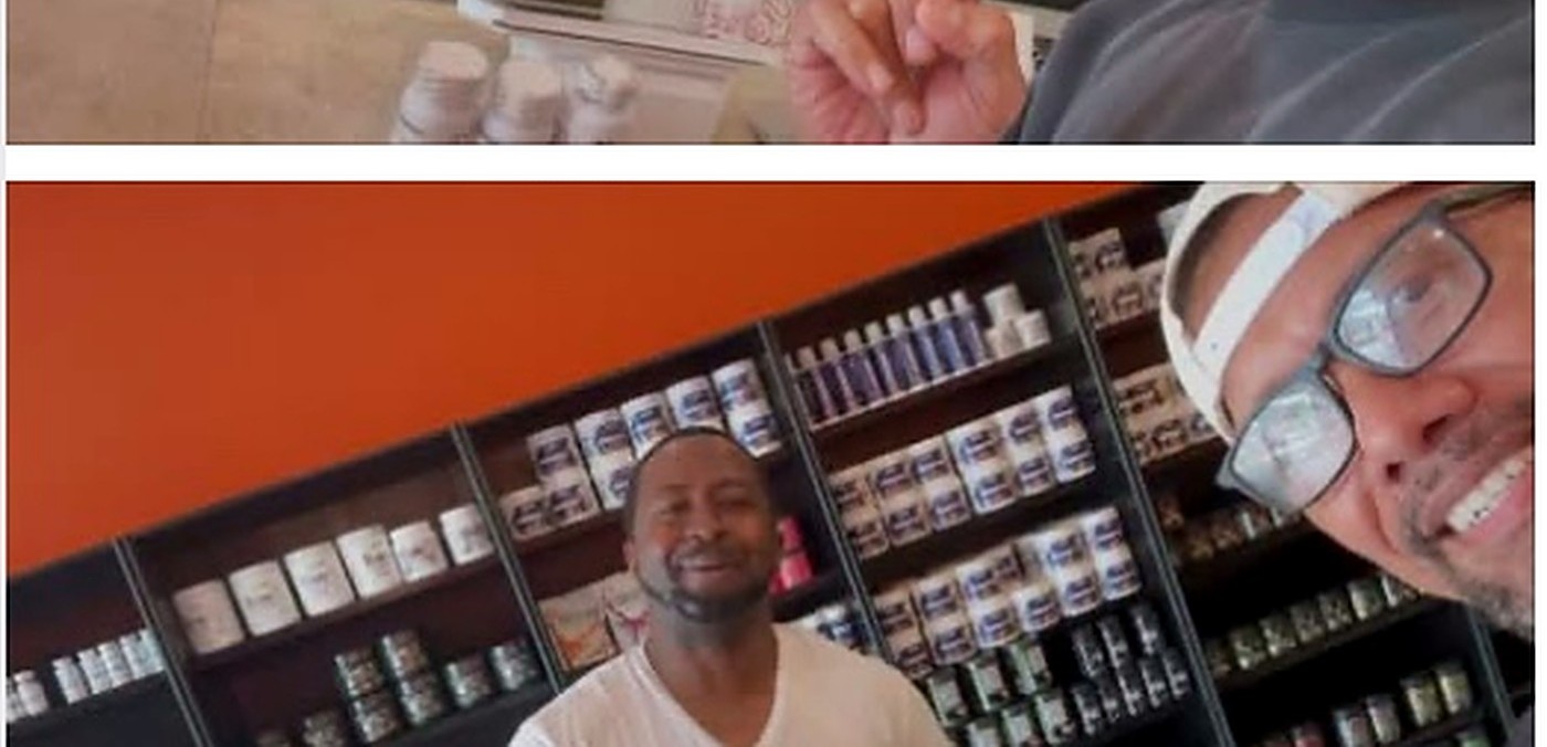 Customer smiling in front of the shelves at Xtreme Performance Nutrition in Gonzales